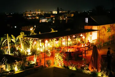 a restaurant lit up at night with lights at Riad Nashira & Spa in Marrakech