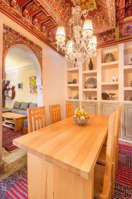 a dining room with a table with a bowl of fruit at Riad Privé De Luxe Au Coeur De La Kasbah Avec Hammam in Marrakech