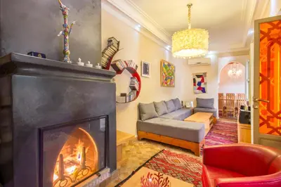 a living room with a fireplace and a couch at Riad Privé De Luxe Au Coeur De La Kasbah Avec Hammam in Marrakech