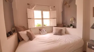 a bed in a room with a window at Riad Kasbah Baraka in Marrakech