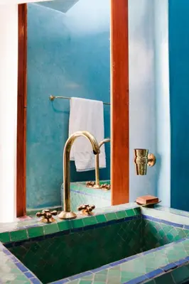 a bathroom with a sink and a mirror at Riad Alkaderi in Marrakech