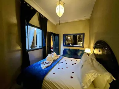 a bedroom with a large bed with blood on it at Riad ART DE VIVRE avec Jacuzzi in Marrakech