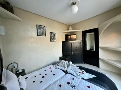 a bedroom with a bed with red hearts on it at Riad ART DE VIVRE avec Jacuzzi in Marrakech