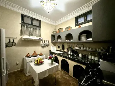 a kitchen with a table with fruits on it at Riad ART DE VIVRE avec Jacuzzi in Marrakech