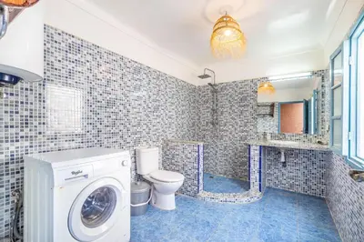 a bathroom with a washing machine and a toilet at Exclusive private Riad in Marrakech