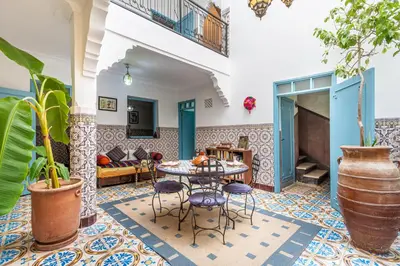 a living room with a table and chairs at Exclusive private Riad in Marrakech