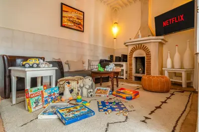 a living room filled with toys and a fireplace at RIAD AWINATI Location Privatisée ,piscine chauffée , beau Rooftop in Marrakech