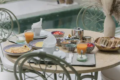 a table with breakfast foods and drinks on it at Riad Sierra in Marrakech