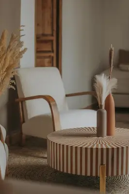 a living room with a chair and a ottoman at Riad Sierra in Marrakech