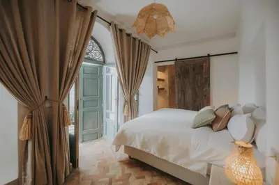 a bedroom with a bed with pillows and a window at Riad Sierra in Marrakech