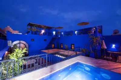a villa with a swimming pool at night at Riad ViewPoint in Marrakech