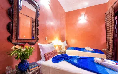 a hotel room with two beds and a mirror at Riad ViewPoint in Marrakech