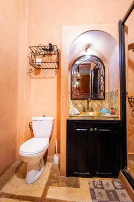 a bathroom with a toilet and a sink and a mirror at Riad ViewPoint in Marrakech