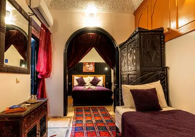 a bedroom with a bed and a mirror at Riad ViewPoint in Marrakech