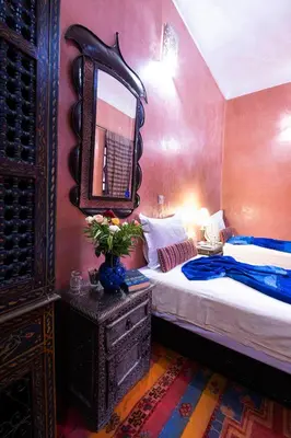 a bedroom with a bed and a mirror on the wall at Riad ViewPoint in Marrakech