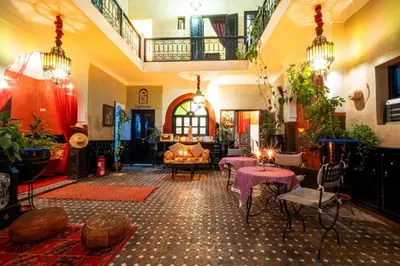 a living room with tables and chairs in a building at Riad ViewPoint in Marrakech