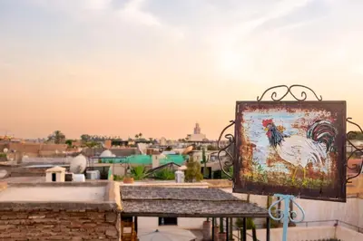 a painting of a rooster on a sign on a roof at Riad Le Coq Berbère in Marrakech