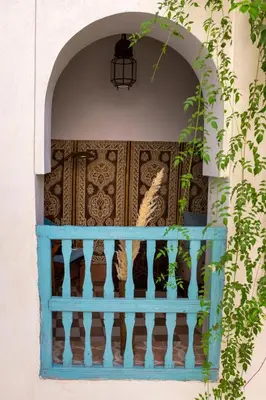 a blue balcony with vases on a wall at Riad Le Coq Berbère in Marrakech