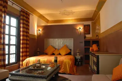 a bedroom with a bed and a sink in it at Riad Minorisa in Marrakech