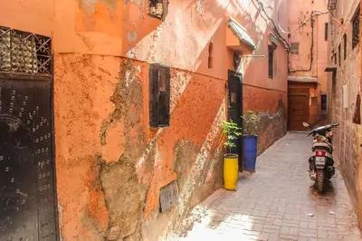 a motorcycle parked on a street next to a building at Riad Minorisa in Marrakech