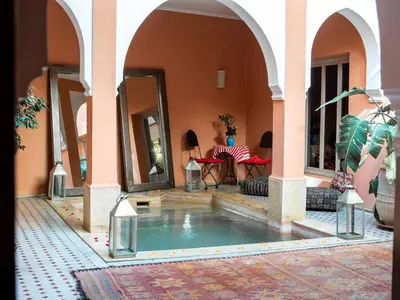 an indoor swimming pool in a house with a courtyard at Riad Tahani in Marrakech