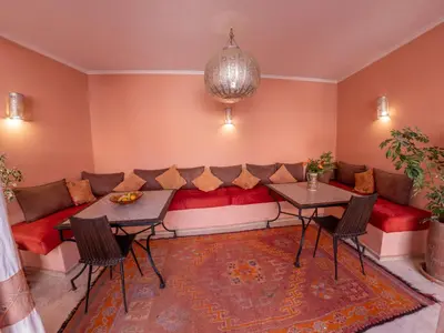 a living room with a couch and tables at Riad Tahani in Marrakech