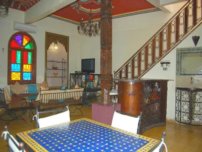 a room with a table and a stained glass window at Résidence Miramare Marrakech in Marrakech
