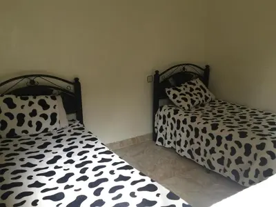 two beds sitting next to each other in a bedroom at Rue Riad Zitoun el Jdid in Marrakech