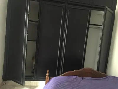a black cabinet with glass doors in a bedroom at Rue Riad Zitoun el Jdid in Marrakech