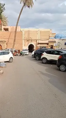 a parking lot with cars parked in front of a building at Rue Riad Zitoun el Jdid in Marrakech