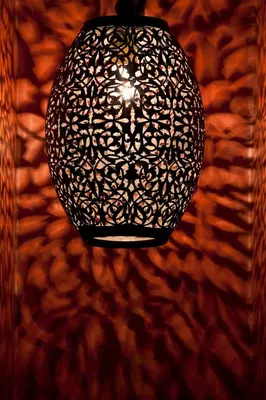 a chandelier hanging from a wall in a room at Riad Les Bougainvilliers in Marrakech