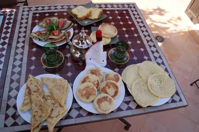 a table with plates of food on top of it at Riad Rabahsadia in Marrakech