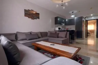 a living room with a couch and a coffee table at Studio au centre wifi Clim in Marrakech
