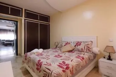 a bedroom with a bed with flowers on it at Studio au centre wifi Clim in Marrakech