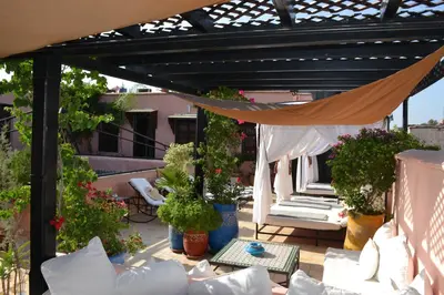 a pergola with a hammock on a patio at Riad Bayti in Marrakech