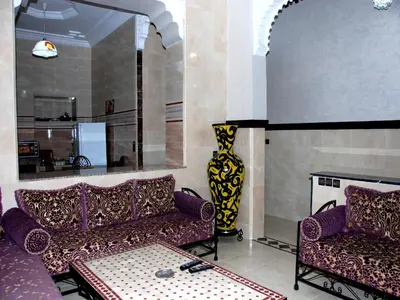 a living room with two couches and a fireplace at Appartements Ziad Guéliz in Marrakech