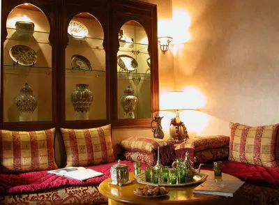 a living room with two couches and a table at Riad Kniza in Marrakech