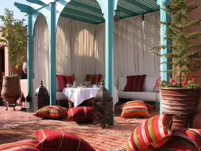 a room with a table and chairs and a table at Riad Kniza in Marrakech