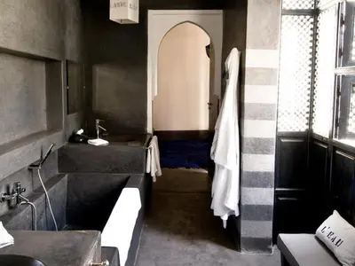 a bathroom with a sink and a bath tub at Riad First in Marrakech