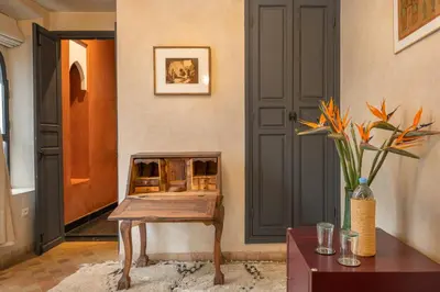 a room with a wooden table and a door at Riad D'ari in Marrakech