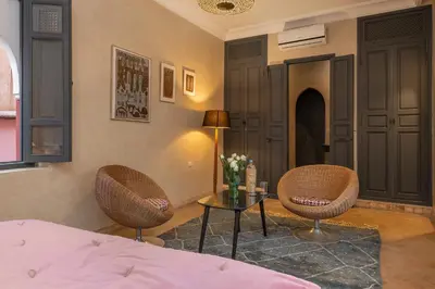 a bedroom with two chairs and a table and a bed at Riad D'ari in Marrakech