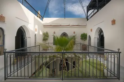 a balcony of a building with plants on it at Riad D'ari in Marrakech