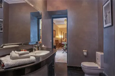 a bathroom with a sink and a toilet and a mirror at Riad D'ari in Marrakech