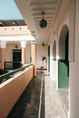 an empty corridor of a building with a ceiling at Riad Albatoul in Marrakech