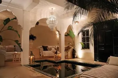 a living room with a pool in the middle of a room at Riad SHIRAZ in Marrakech