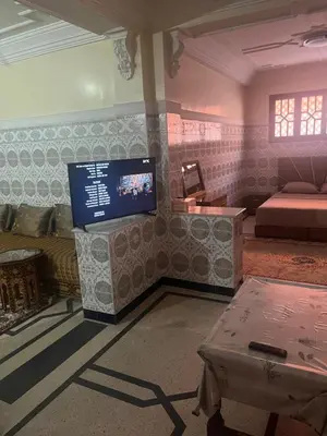 a living room with a tv and a couch at GoodLife House in Marrakech