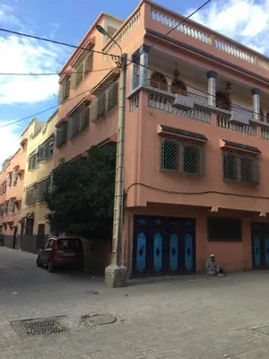 a building with blue doors on the side of a street at GoodLife House in Marrakech
