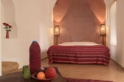 a bedroom with a bed and a bowl of fruit at Riad O2 in Marrakech