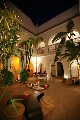 a large room with plants and a table in it at Riad O2 in Marrakech