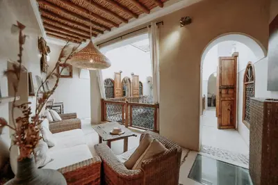 a living room with a couch and a table at Dar Nour el Houda in Marrakech